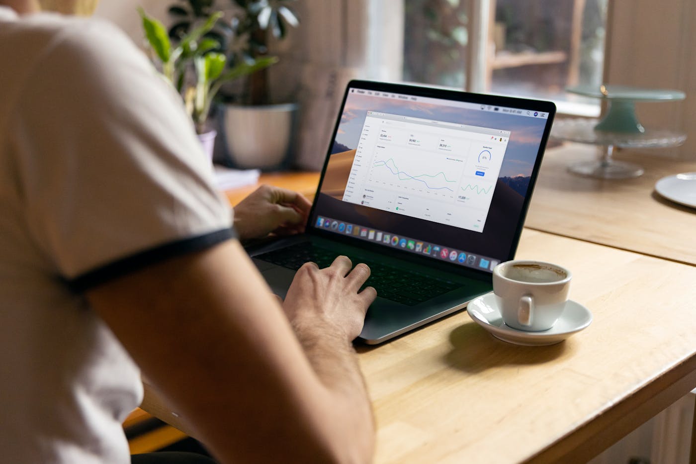A marketer reviewing email campaign performance on a laptop in a focused workspace