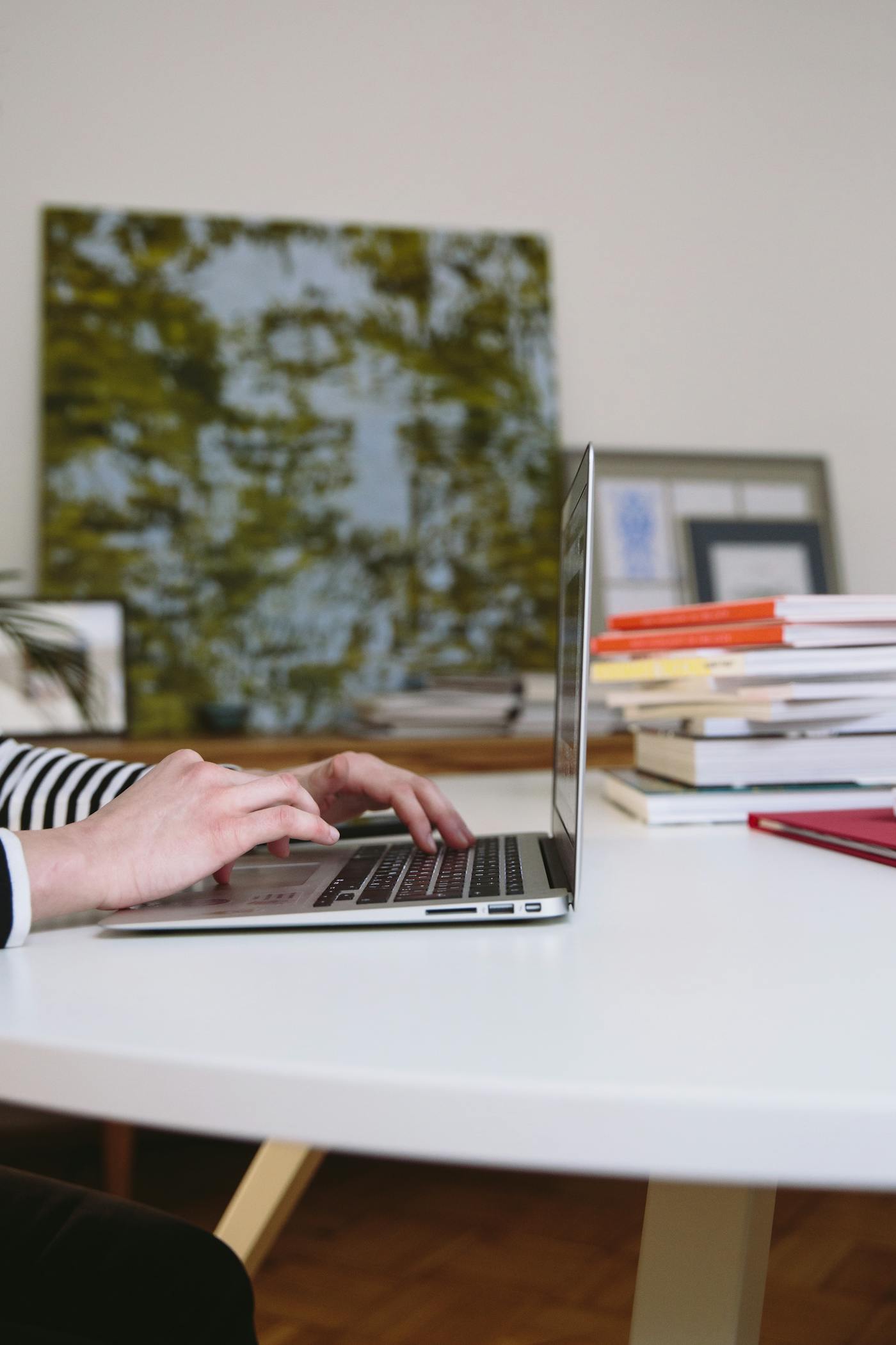 A professional working through digital process tasks on a laptop at a desk