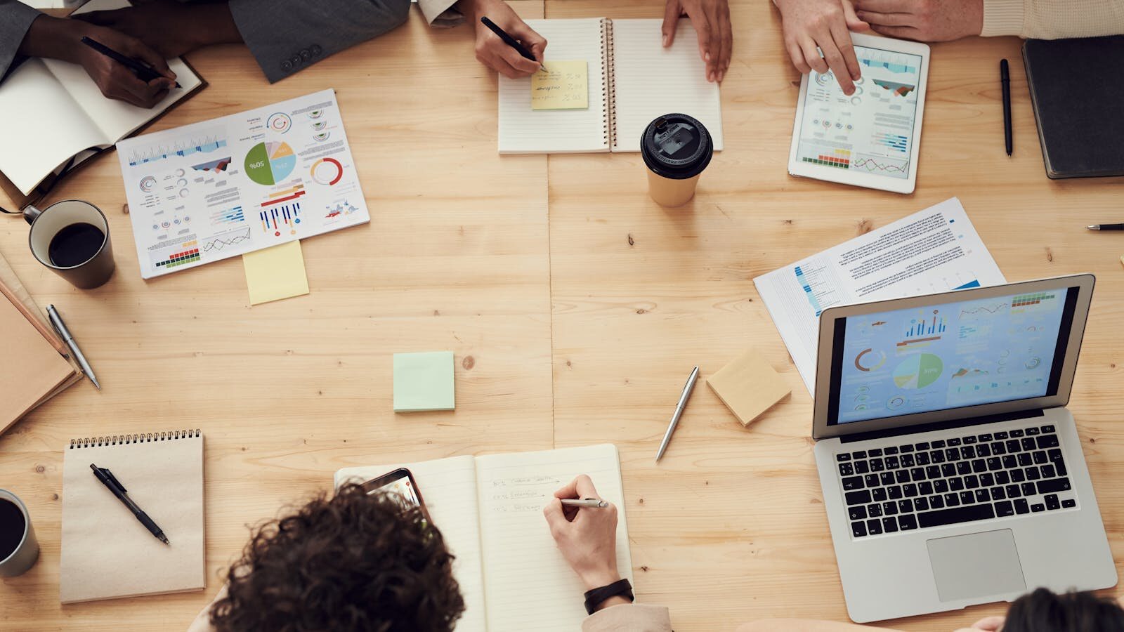 A group discussing options around a table during a proposal review meeting